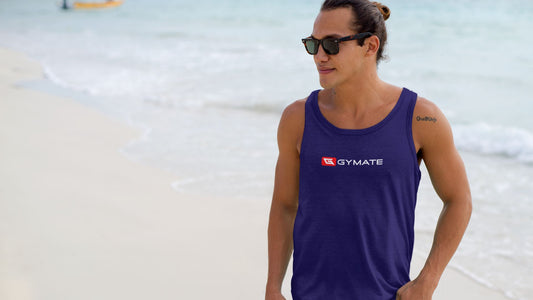 Man on beach wearing a branded gymate vest mens clothes for gym